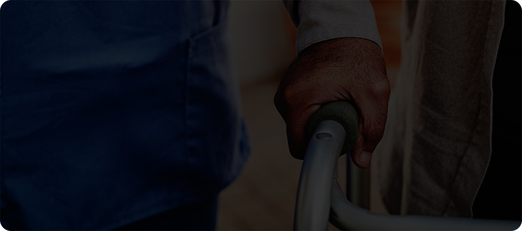 closeup of a person’s hand grasping a walker